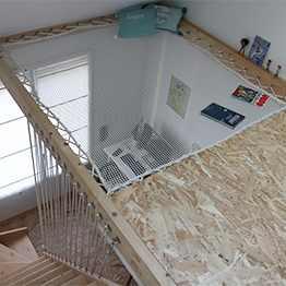 Hammock floor installation in a teen's bedroom under a sloped ceiling with a skylight