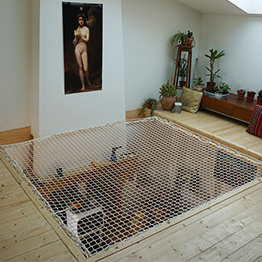A white suspended net over a living room 